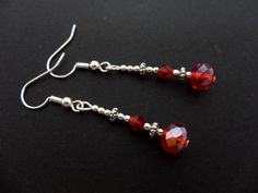 This a pair of pretty little silver plated red crystal bead dangly earrings. Measure approx. 4cm from top of hook to bottom of earring. These earrings are for pierced ears. Freshly made by me and unworn. Thanks for looking!! Red Handmade Dangle Crystal Earrings, Red Handmade Crystal Dangle Earrings, Handmade Red Crystal Dangle Earrings, Handmade Red Crystal Drop Earrings, Red Sterling Silver Drop Earrings, Handmade Red Crystal Earrings For Gift, Metal Beaded Earrings With Faceted Beads For Gifts, Nickel-free Red Drop Earrings Jewelry, Adjustable Metal Earrings With Faceted Beads