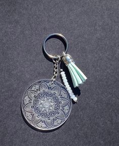 a keychain with a tassel hanging from it's side on a black surface