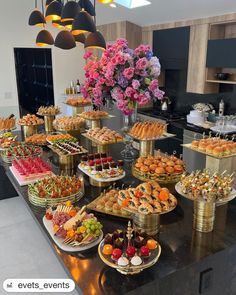 a table filled with lots of different types of food on top of it's trays