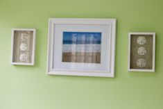 three framed pictures hang on the wall next to each other in front of a green wall