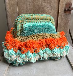 a crocheted purse sitting on top of a wooden chair