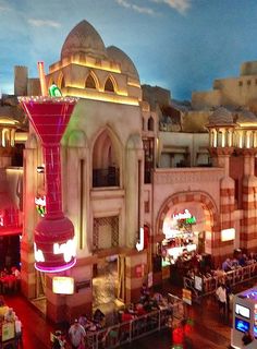 an aerial view of a city at night with people walking around and onlookers