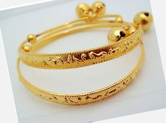 Handmade item from Thailand Materials: Brass, Gold Real 18k & 24K gold plated/Nickel free This is a set of two brand new 23K Thai gold new born anklet bracelet. They measure diameter 4.5-5.5 CM Circumference: 17 CM Adjustable Weight about: 13 grams The anklet can be enlarged so the feet of a baby can insert easily. The round ball is ringing FREE JEWELRY BAG WITH EVERY ITEM Description All gold plated jewelry was sent directly to us from the manufacturer in Bangkok This Unique Jewelry Is Bras Adjustable Gold Bracelet For Festive Occasions, Adjustable Gold Bracelet For Ceremonial Occasions, Traditional Gold Anklets With Adjustable Fit, Traditional Gold Adjustable Anklets, Traditional Gold Anklets Adjustable, Bell Anklet, Jewelry Bag, Baby Set, Anklet Bracelet