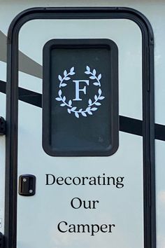 a sign that says decorating our camper on the side of a white trailer