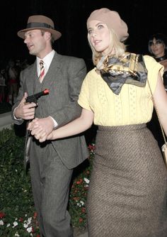 a man and woman dressed in vintage clothing