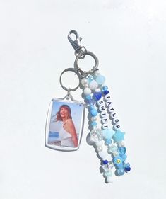 a keychain with a photo and beads hanging from it