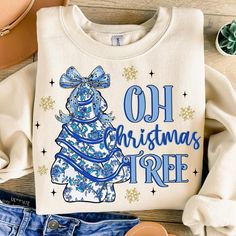 a t - shirt that says oh christmas tree on it next to some shoes and other items