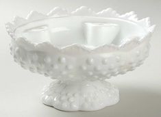 a white bowl with two cups in it