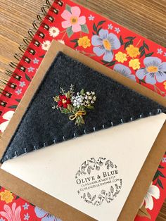 an envelope with a flower pin attached to it