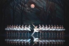 the ballet is performing on stage with their reflection in the water