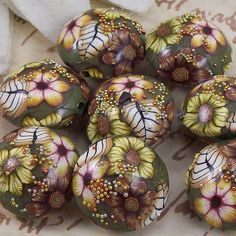 there are many flowers painted on these beads