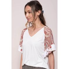 Solid knit top with lace short sleeves and floral printed rufflesSelf: Modal Polester 33%Contract: Nylon 100%Made in United States