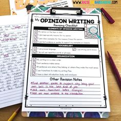 an open notebook with writing on it next to pencils and paper notes that read opinion writing