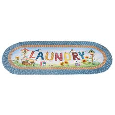 a blue and white oval rug with the word laundry on it's side, in front of a white background