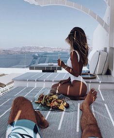 a woman sitting on the ground eating food