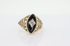 This is a super unique ring.  Excellent Pinkie ring. Onyx stone with a diamond center in a star setting.  Condition: Has been previously resized and shows signs. Resize will hold and not seen and worn, but probably will need to be addressed. Please buy accordingly. Details: 10k Yellow Gold 6mm by 12mm marquise Onyx 4mm rise 1mm diamond 1.7grams sz4.5 Antique Black Rings With Rose Cut Diamonds, Antique Oval Diamond Ring With Bezel Setting, Vintage 14k Gold Diamond Ring With Bezel Setting, Antique Collectible Jewelry With Diamond Accents, Classic Black Ring With Single Diamond, Vintage Marquise Center Stone Jewelry, Antique Diamond Ring With Bezel Setting, Victorian 14k Gold Jewelry With Single Diamond, Classic Black Jewelry With Single Diamond