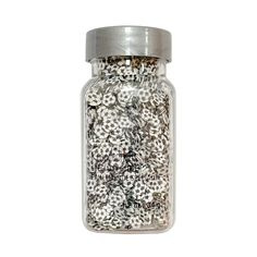 a jar filled with lots of white and silver buttons