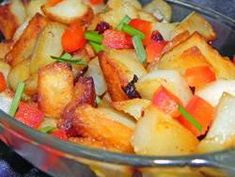 a glass bowl filled with potatoes and carrots