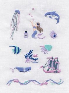 embroidery designs on white fabric with blue and pink accents, including an octopus, jellyfish, seahorse, starfish