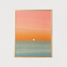 an orange, pink and blue painting hanging on a wall next to a white wall