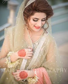 a woman wearing a veil and holding flowers