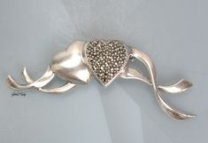 "Vintage designer JJ sterling silver 925 two Hearts pin/brooch. It is in very good condition, new old stock. It measures 2 5/8 inches long and 7/8\" tall. The weight of it is 0.4 oz. It is quality marked JJ Sterling. We combine shipping, If you want to take advantage of the reduced shipping you must contact us before you pay for your items so we can send you a corrected invoice. Thank You for visiting our Etsy store https://www.etsy.com/shop/VictoryIssweet !" Elegant Silver Heart Brooch, Elegant Silver Heart-shaped Brooch, Elegant Silver Heart-shaped Brooches, Elegant Silver Heart Brooches, Sterling Silver Brooches For Anniversary, Silver Heart-shaped Brooch For Valentine's Day, Silver Heart Brooch For Valentine's Day, Silver Brooches For Anniversary On Valentine's Day, Valentine's Day Silver Heart Brooch