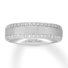 a white gold ring with diamonds on the sides and an inscription neil lane written across it