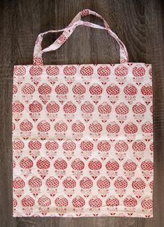 This holiday season, replace wrapping paper with a zero-waste and sustainable way to wrap presents while also being a part of the present - our block print cotton tote bags! Beautiful and eco-friendly, these reusable totes feature colourful designs block printed on 100% cotton that is lightweight yet sturdy. These cloth bags are great as reusable shopping bags for everyday use or to carry around as a stylish accessory! - Hand block printed by artisans on 100% cotton - Well-stitched, lightweight, Wrap Presents, Zero Waste Gifts, Red Tote Bag, Holiday Gift Bag, Red Tote, Christmas Gift Shop, Cloth Bag, Reusable Shopping Bags, Market Bag