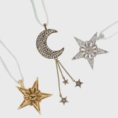 three stars and a crescent hanging from a string