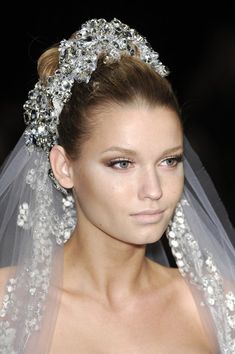 a woman in a wedding dress with a veil on her head