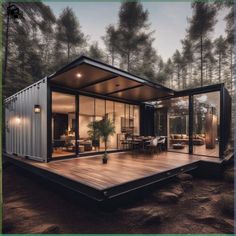 a house made out of shipping containers sitting on top of a wooden deck in the middle of a forest