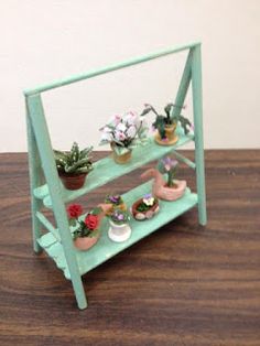 a shelf with potted plants on top of it