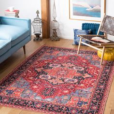 a living room filled with furniture and a red rug