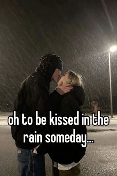 a man and woman kissing in the rain with text saying oh to be kissed in the rain