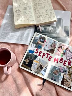 an open book sitting on top of a pink blanket next to a cup of coffee