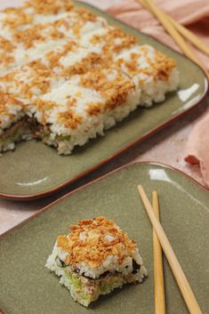 two green plates with food on them and chopsticks next to one plate that has rice