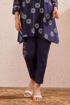 Navy blue three fourth sleeves block printed tapered V neck tunic in chanderi base with lace detailing on sleeves. Paired with side striped straight pant and an inner.
Components: 3
Pattern: Print
Type Of Work: Floral Block
Neckline: V Neck
Sleeve Type: Three Fourth
Fabric: Chanderi
Color: Blue
Other Details: 
Model Height: 5ft 4inches, wearing size S
Occasion: Puja, Mehendi and Haldi - Aza Fashions Traditional Bottoms With Printed Motifs For Eid, Cotton Sets With Dupatta And Straight Pants, Eid Chanderi Straight Pants, Blue Cotton Pants For Festive Occasions, Chanderi Straight Pants For Diwali, Traditional Printed Kurta For Workwear, Traditional Workwear Kurta With Printed Motifs, Traditional Block Print Pants, Straight Work Pants For Eid