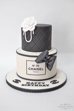 a black and white chanel cake with pearls on top