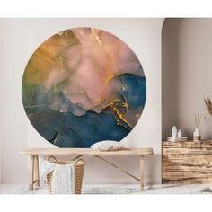 an abstract painting on the wall in a living room with a wooden table and chair