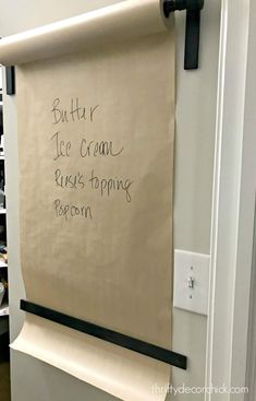 a white board with writing on it in a room next to a book shelf filled with books