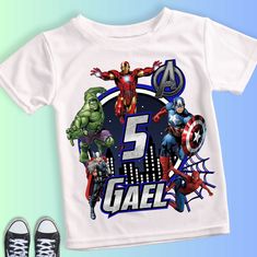 a t - shirt with the avengers logo on it next to shoes and a pair of sneakers