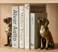 two bookshelves with dog figurines on them