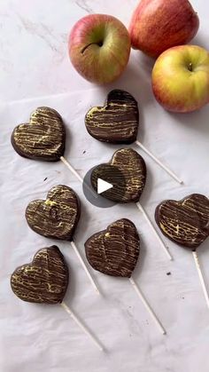 apples and chocolate hearts on sticks with an apple in the background