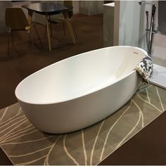 a white bath tub sitting on top of a rug