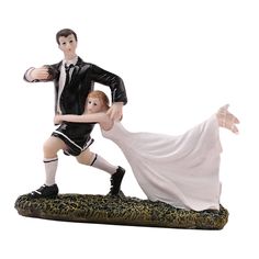 a bride and groom figurine holding each other