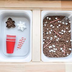 two trays filled with food and drinks on top of a wooden table next to each other