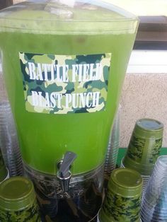 a green beverage machine with plastic cups around it