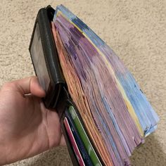 a hand holding a wallet full of credit cards