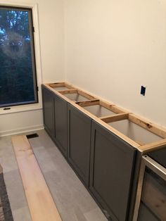 an unfinished kitchen with cabinets in the middle