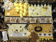 a table topped with lots of different types of items on top of a black and yellow cloth